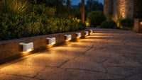 Path solar lights along formal garden pathway at evening
